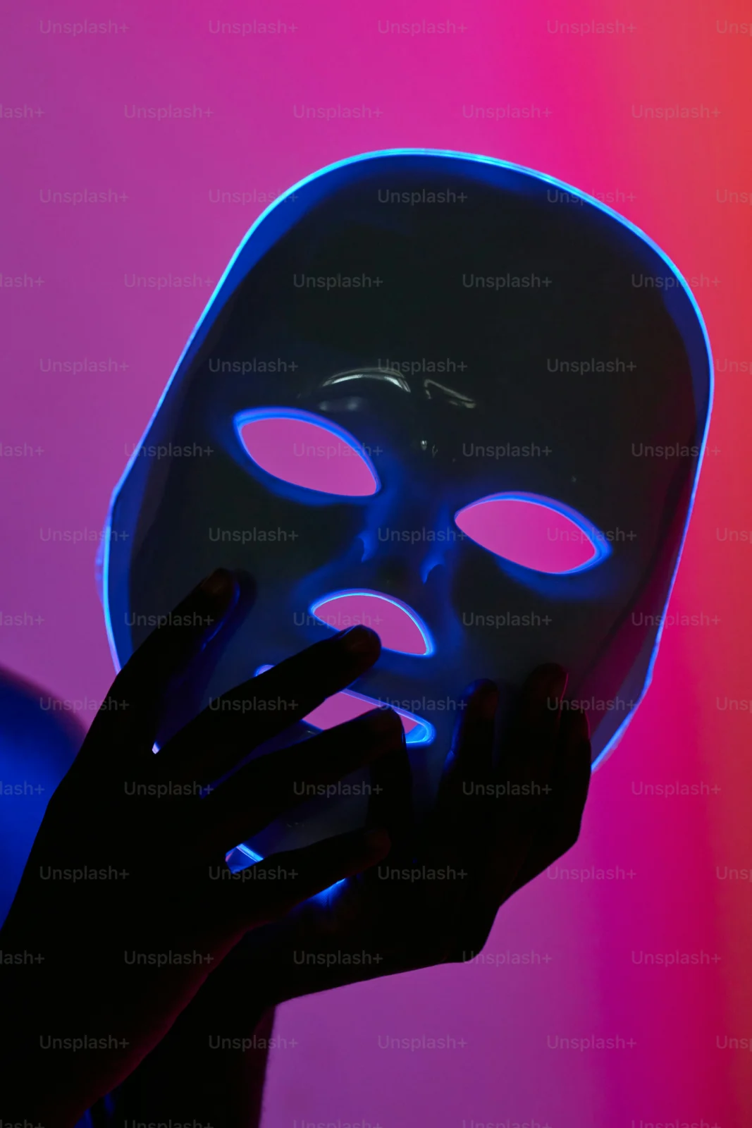 Festival attendee wearing Beatnix Costume Shop LED scary masks at night with glowing neon lights