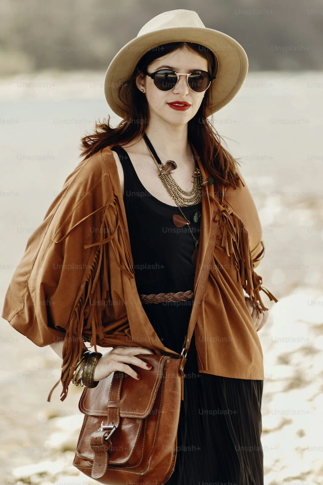 Woman wearing Beatnix Costume Shop fringe outfits at a beach music festival during sunset