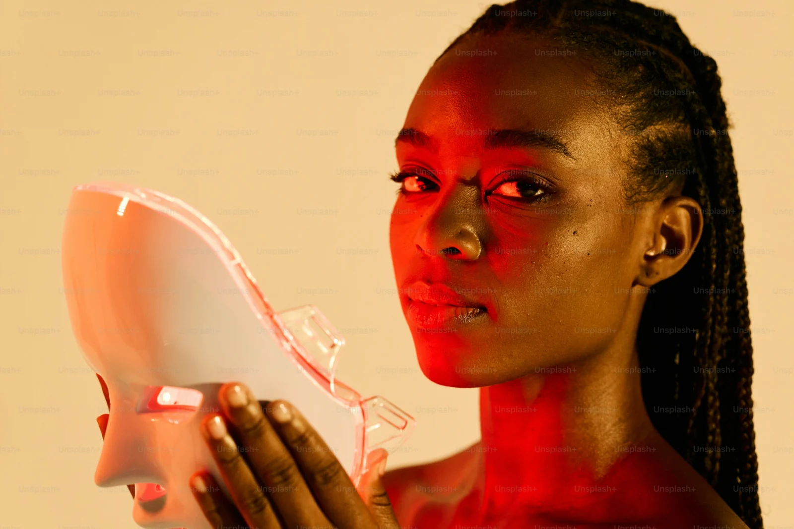 Festival attendee adjusting smart rave masks using a smartphone app before an event