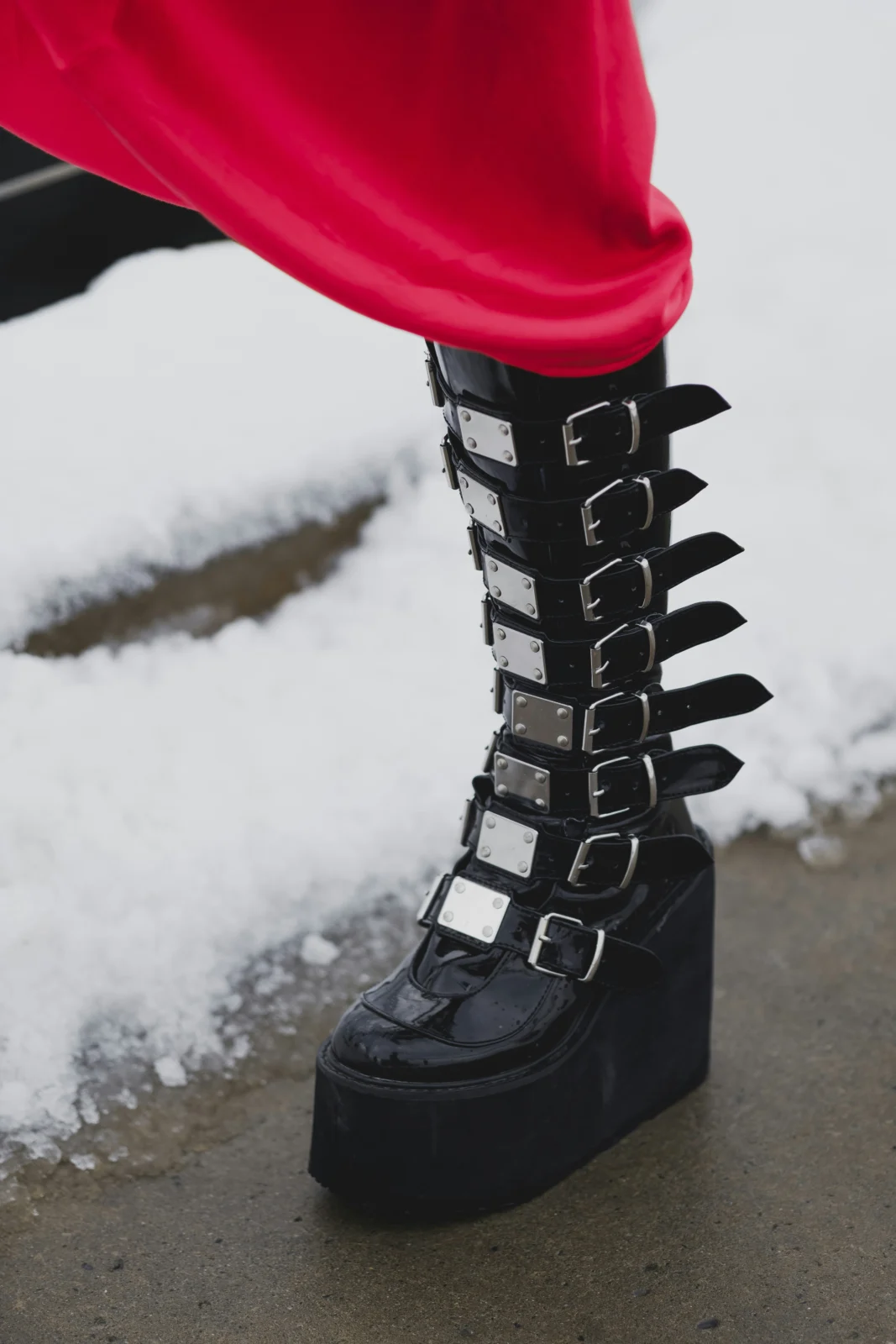 Festival attendee wearing comfortable rave footwear with chunky platform boots during an evening event