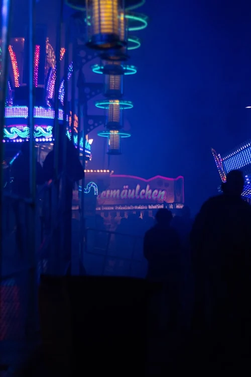 EDM festival crowd with a Beatnix Costume Shop neon mask glowing in the dark