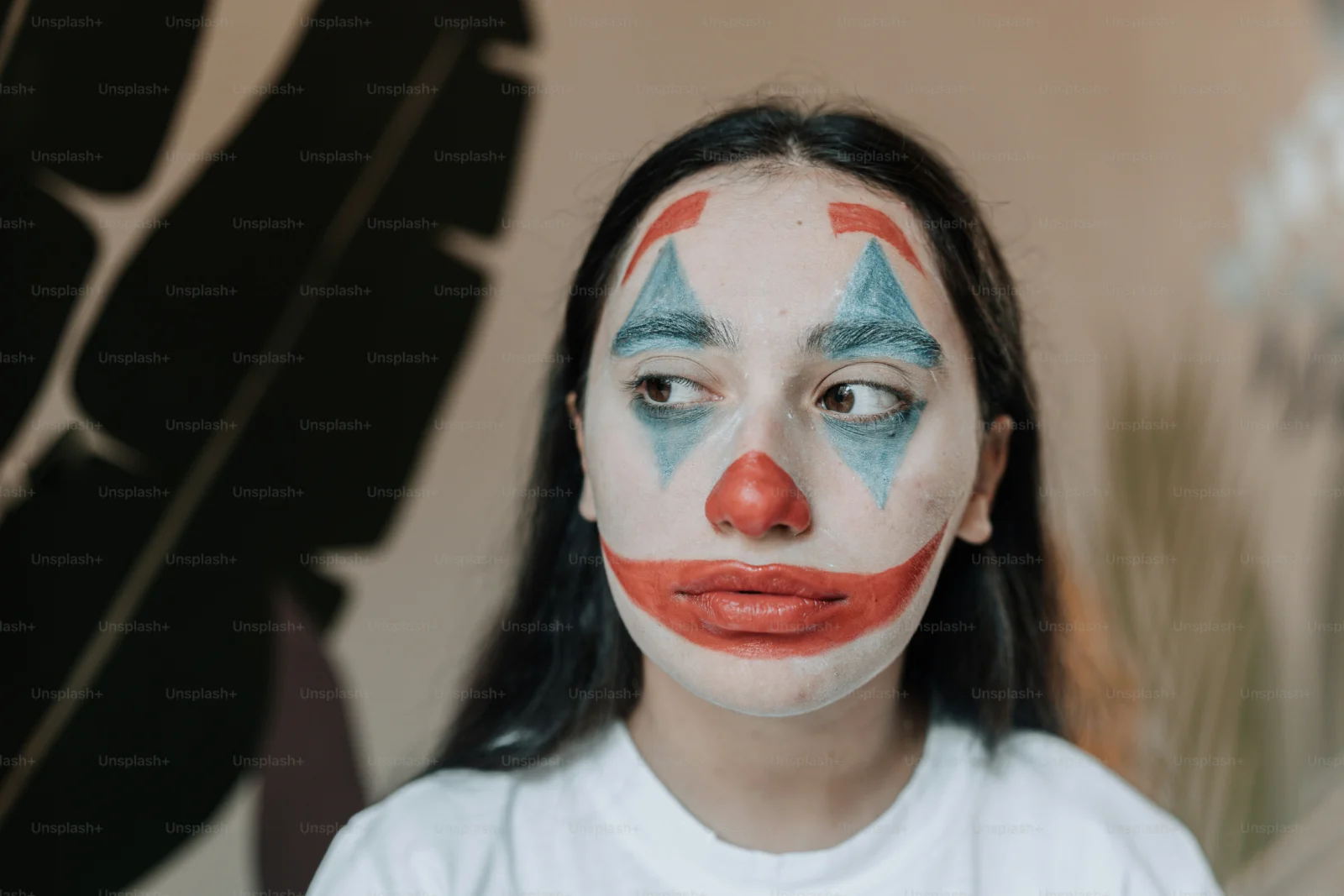 Halloween performer wearing Beatnix Costume Shop clown masks at a nighttime horror event