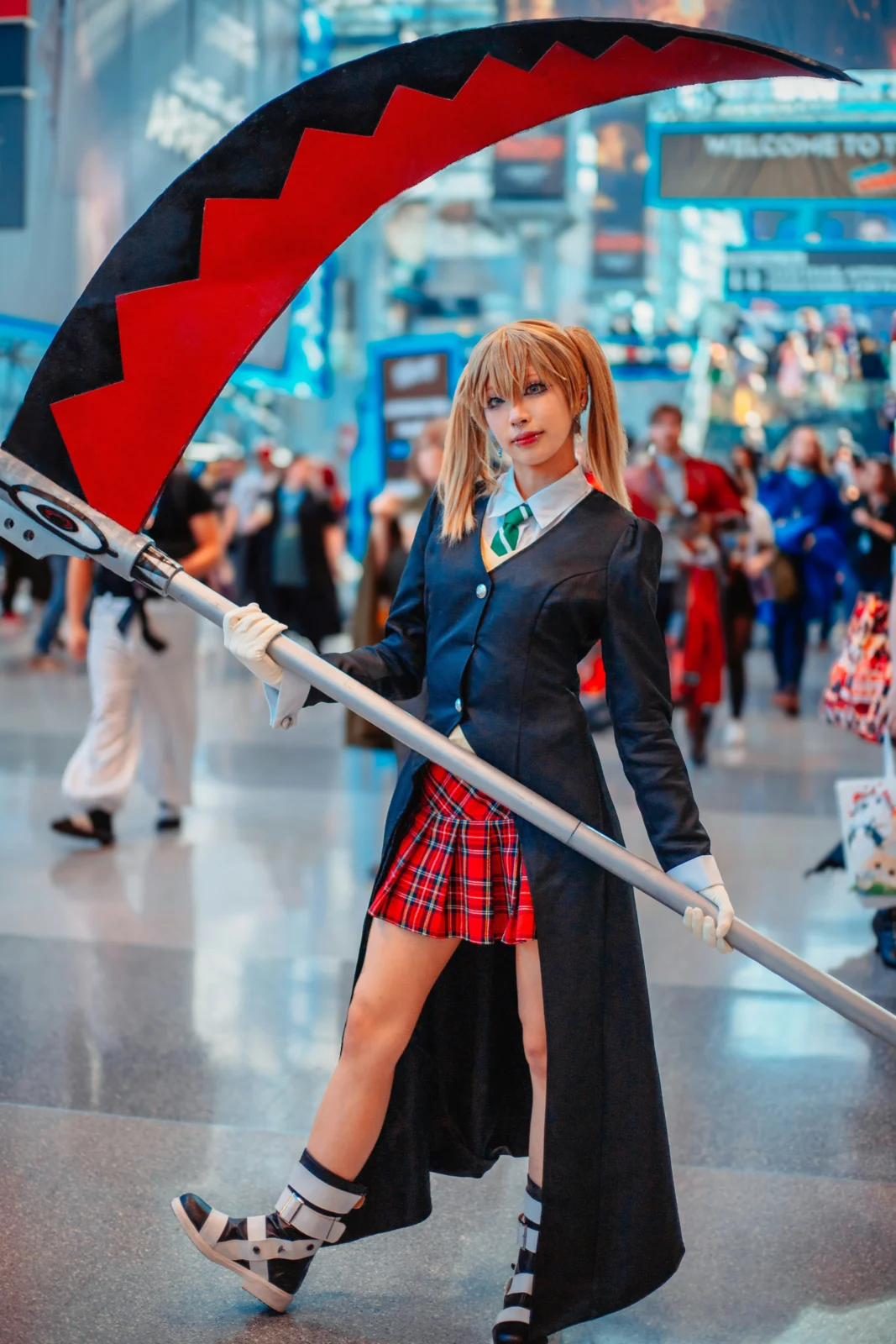 Cosplayer carrying Beatnix Costume Shop cosplay props at a busy anime convention