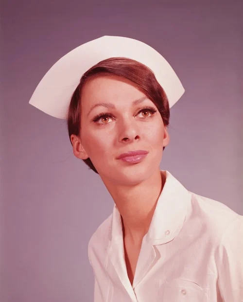 Woman wearing Beatnix Costume Shop nurse costumes at a Halloween party with red and white styling